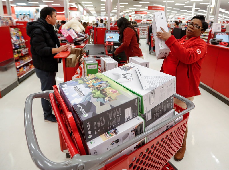 Store employee helps a customer with his purchase during the Black Friday sales event on Thanksgiving Day at Target in Chicago Illinois U