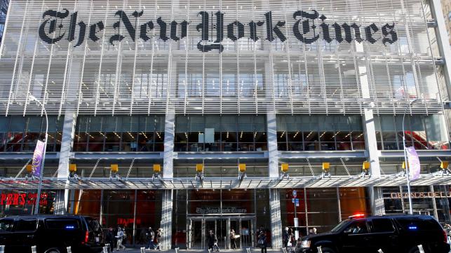 The motorcade of US President-elect Donald Trump makes its way past the New York Times building after a meeting in New York