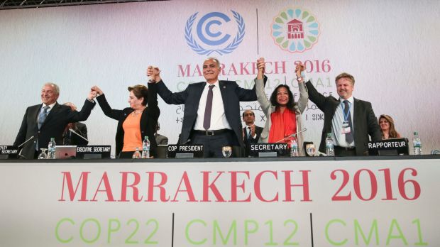 UN climate chief Patricia Espinosa second left and Morocco's Foreign Minister Salaheddine Mezouar centre celebrate