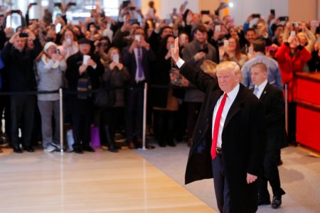 U.S. President-elect Donald Trump gestures from the front door at the main clubhouse at Trump National Golf Club in Bedminster New Jersey U.S