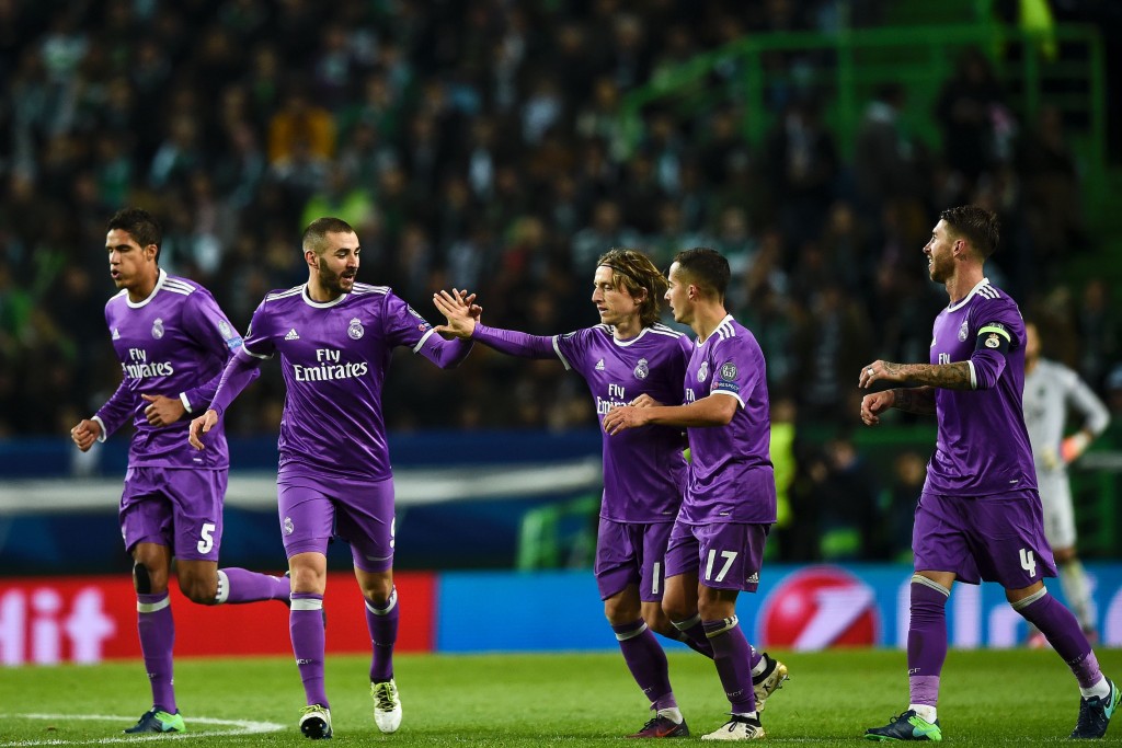 TOPSHOT- Real Madrid's French forward Karim Benzema celebrates with his teammate Real Madrid's Croatian midfielder Luka Modric after scoring a goal during the UEFA Champions League football match Sporting CP vs Real Madrid CF at the Jose Alvala