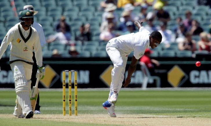 Cricket- Australia v South Africa- Third Test cricket match- Adelaide Oval Adelaide Australia- 25/11/16. South African bowler Kagiso Rabad delivers the pink ball to Australia's captain Steve Smith as Australian batsman Usman Kha