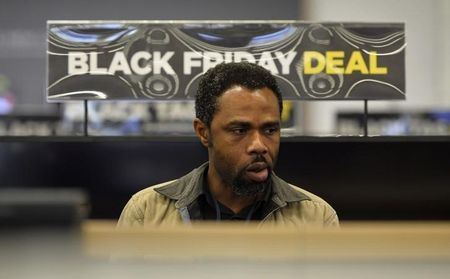 A shopper looks at retail items on Black Friday at a store in Croydon