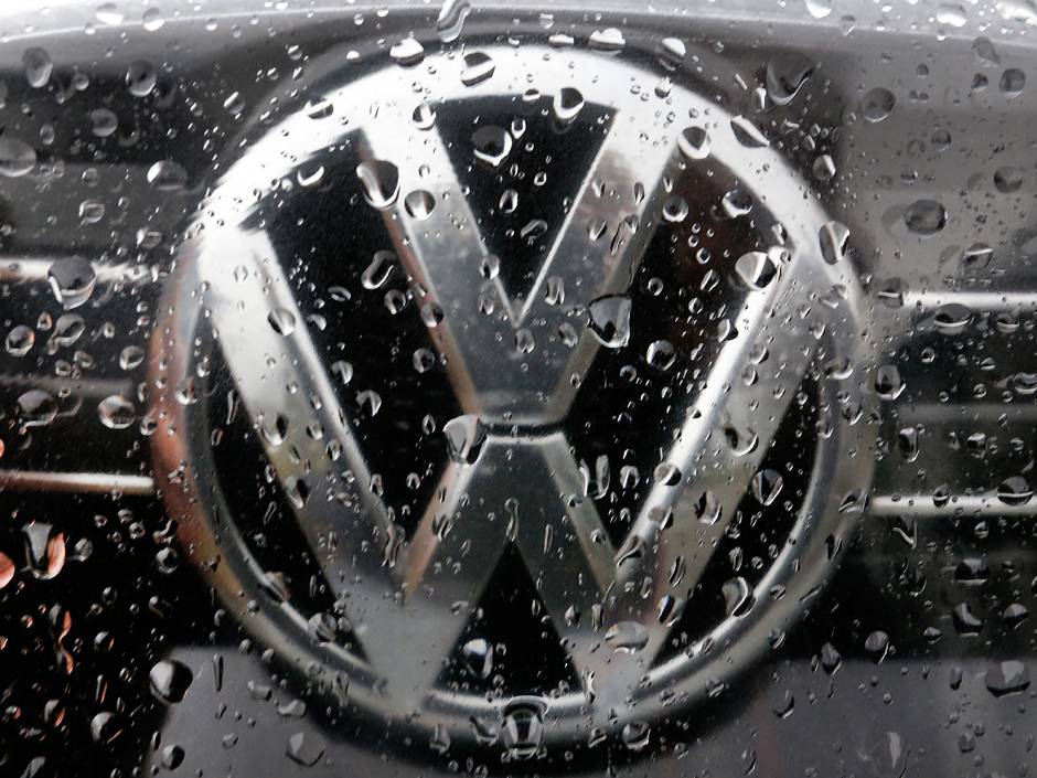 Volkswagen AG reached a landmark agreement with workers to cut as many as 30,000 jobs globally