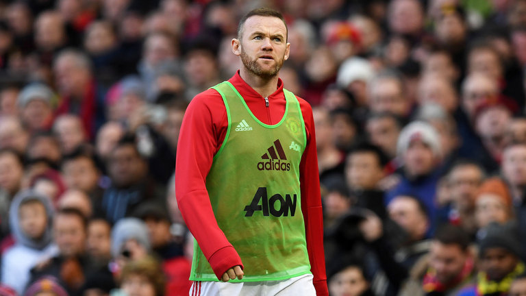 Wayne Rooney warms up on the touchline at Old Trafford