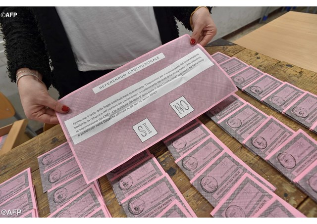 A polling station officer shows a ballot on the eve of a crucial referendum on constitutional reforms.- AFP