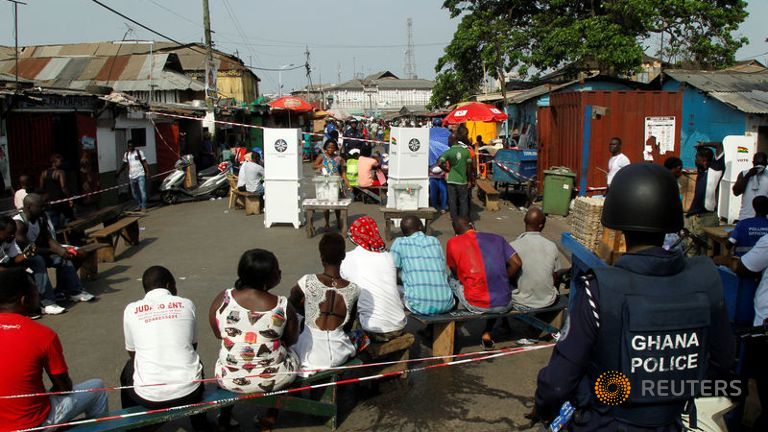 A woman casts her vote during the presidential election in Accra