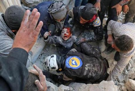 Rescue workers removed a child after an attack Thursday in Aleppo. UN officials say 100,000 children remain in the city