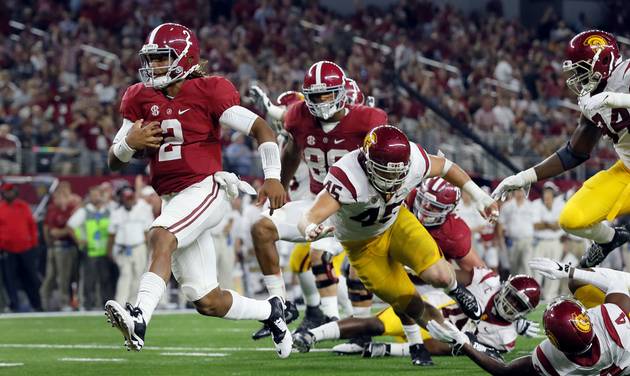 Alabama quarterback Jalen Hurts slips into the end zone on a 7-yard touchdown run during the second half of an NCAA college football game against Southern California in Arlington Texas. Freshman Jalen Hurts was