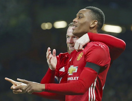 Manchester United's Anthony Martial right celebrates with teammate Wayne Rooney after scoring his side 2nd goal of the game during their English League Cup quarterfinal match against West Ham United at Old Trafford in Manchester Wednesday Nov. 30. (AP