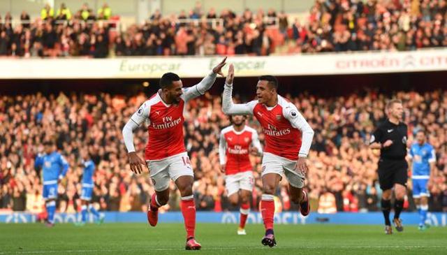 Arsenal's Alexis Sanchez  celebrates with teammate Theo Walcott after scoring the opening goal against Bournemouth at the Emirates Stadium