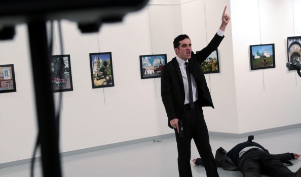 ADDS THE NAME OF THE GUNMAN- A man identified as Mevlut Mert Altintas shouts after shooting Andrei Karlov the Russian