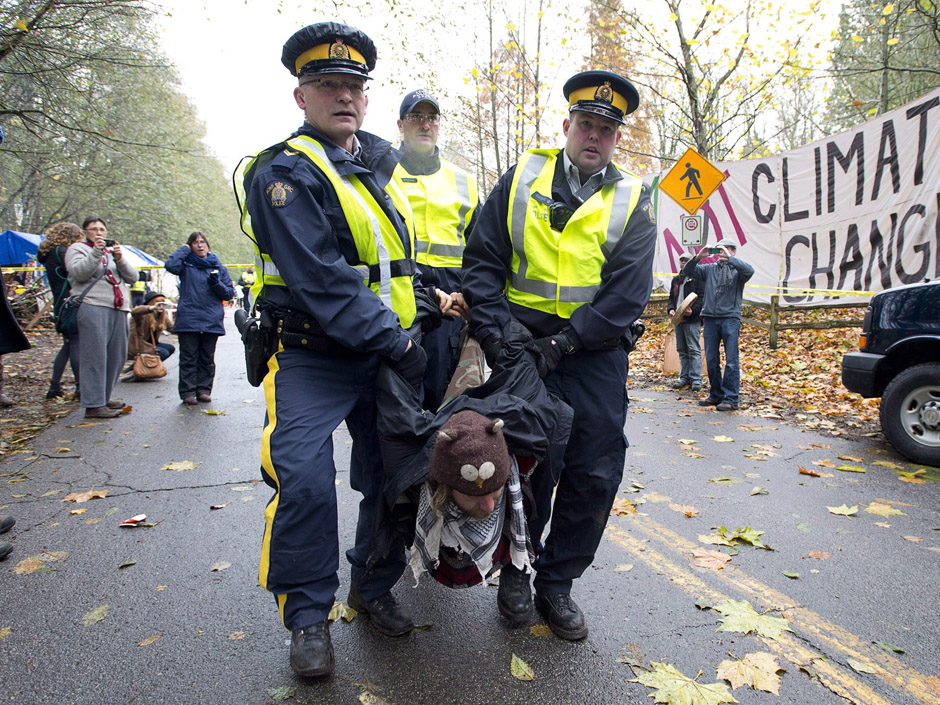 RCMP officers take protesters into custody at an anti-pipeline demonstration in Burnaby B.C. on Nov. 20 2014. The Liberal government’s approval of the Kinder Morgan Trans Mountain pipeline has sparked outrage — and praise from business groups