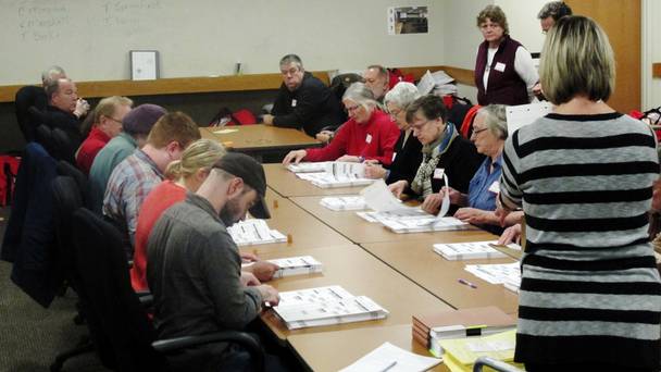 Ballots in Wisconsin are placed in front of workers as a state-wide presidential election recount begins