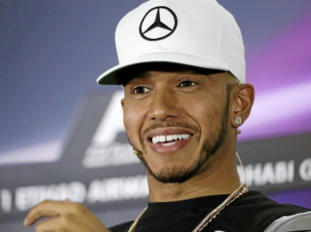 British Formula One driver Lewis Hamilton of Mercedes smiles during a press conference in Abu Dhabi