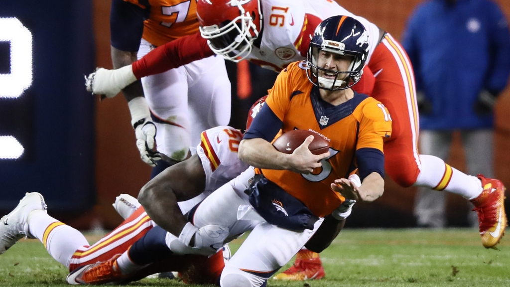 Quarterback Trevor Siemian of the Denver Broncos is tackled by outside linebacker Justin Houston of the Kansas City Chiefs on Nov. 27 2016