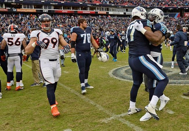 Tennessee Titans tackle Taylor Lewan celebrates with running back De Marco Murray as Denver Broncos defensive tackle Adam Gotsis walks off the field after an NFL football game Sunday Dec. 11 2016 in Nashville Tenn. The Titans won 13-10