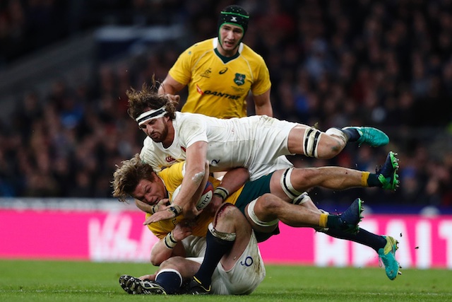 Australia flanker Michael Hooper is tackled by England prop Dan Cole and flanker Tom Wood during their international rugby union test match at Twickenham stadium in south-west London