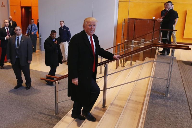 U.S. President elect Donald Trump walks up a staircase to depart the lobby of the New York Times building after a meeting in New York U.S