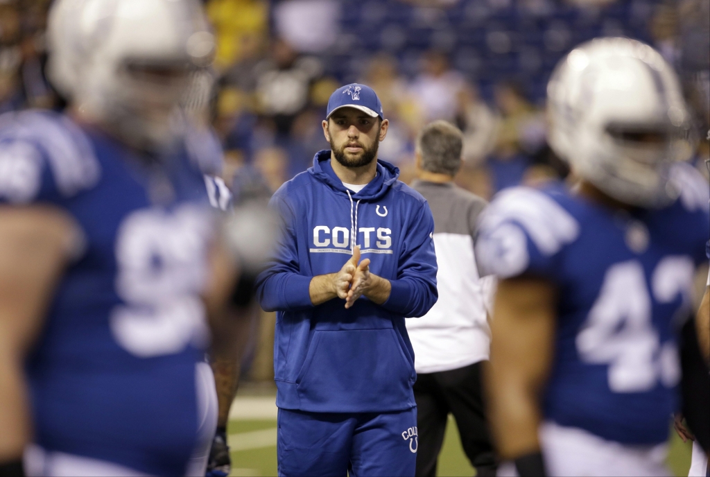 Indianapolis Colts quarterback Andrew Luck watches his teammates warm up before an NFL football game between the Indianapolis Colts and the Pittsburgh Steelers,in Indianapolis. Luck returned to the practice field