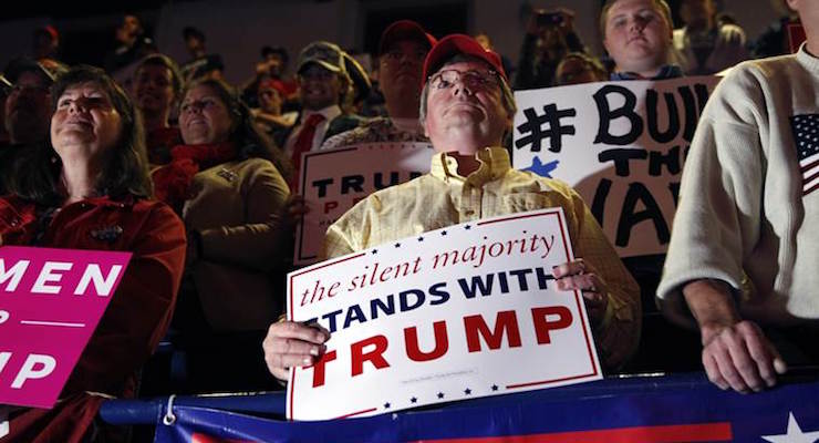 People hold signs during a campaign rally for Republican presidential candidate Donald Trump Monday Nov. 7 2016 in Scranton Pennsylvania