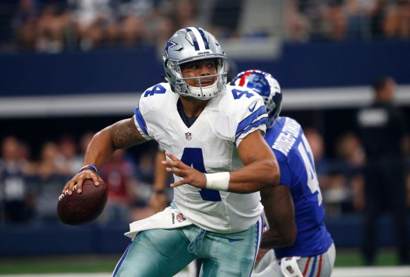 Dallas Cowboys quarterback Dak Prescott scrambles out