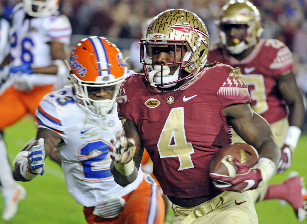 Nov 26 2016 Tallahassee FL USA Florida State Seminoles running back Dalvin Cook runs the ball for a touchdown past Florida Gators defensive back Chauncey Gardner Jr. during the first quarter at Doak Campbell Stadium. Mandatory Credit Melin