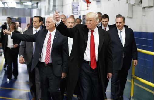 President-elect Donald Trump and Vice President-elect Mike Pence wave as they visit to Carrier factory in Indianapolis Ind. Trump is slamming a union leader who criticized his deal to discourage air cond