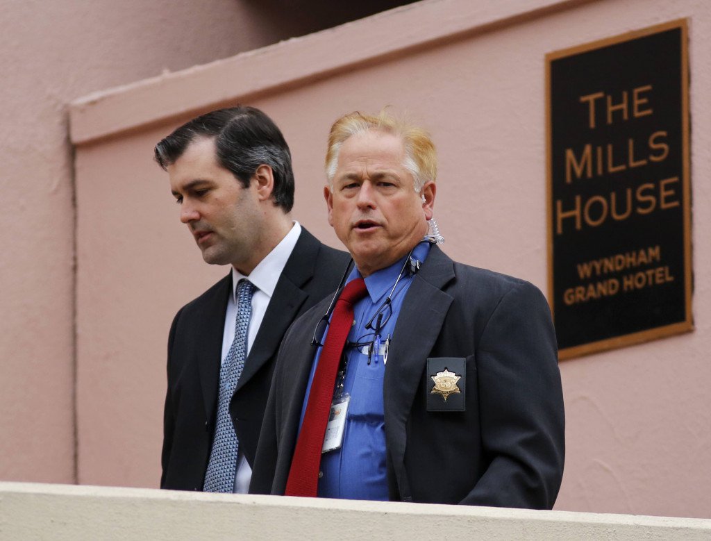 Michael Slager left walks from The Mills House Hotel to the Charleston County Courthouse under the protection from the Charleston County Sheriff's Department during a break in the jury deliberations for his trial on Monday