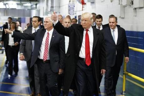 President-elect Donald Trump and Vice President-elect Mike Pence wave as they visit to Carrier factory in Indianapolis Ind. Trump is slamming a union leader who criticized his deal to discourage air cond