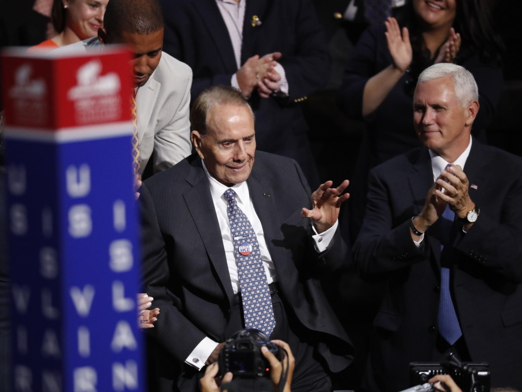 Sen. Robert Dole seated next to then Vice Presidential nominee Mike Pence receives a standing ovation at the Republican National Convention in July