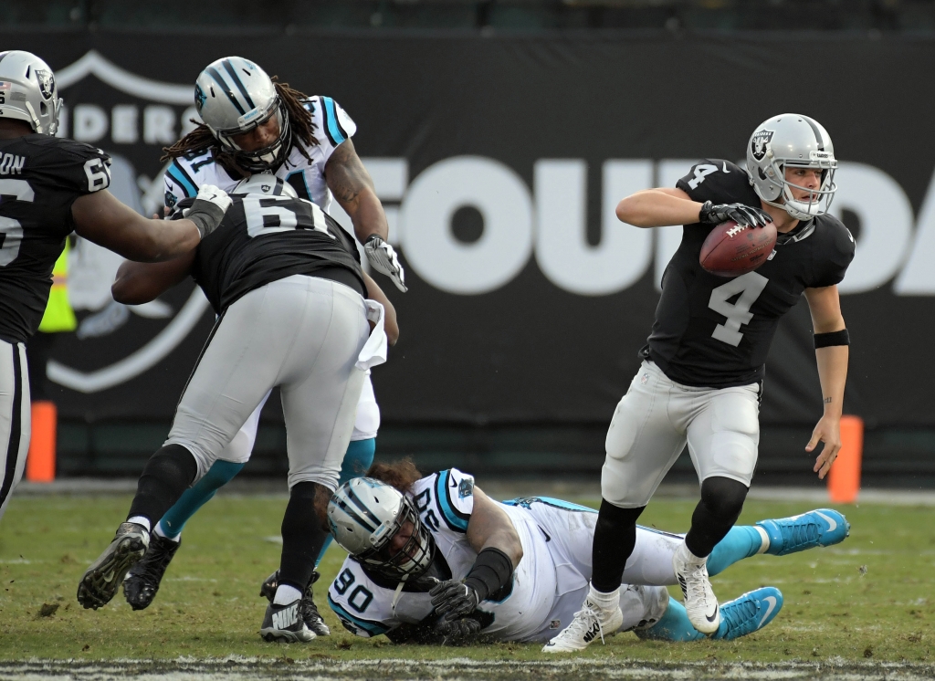 Nov 27 2016 Oakland CA USA Oakland Raiders quarterback Derek Carr scrambles out against the Carolina Panthers defense of defensive tackle Paul Soliai during the second half at Oakland Alameda County Coliseum. Mandatory Credit Kirby Lee-USA