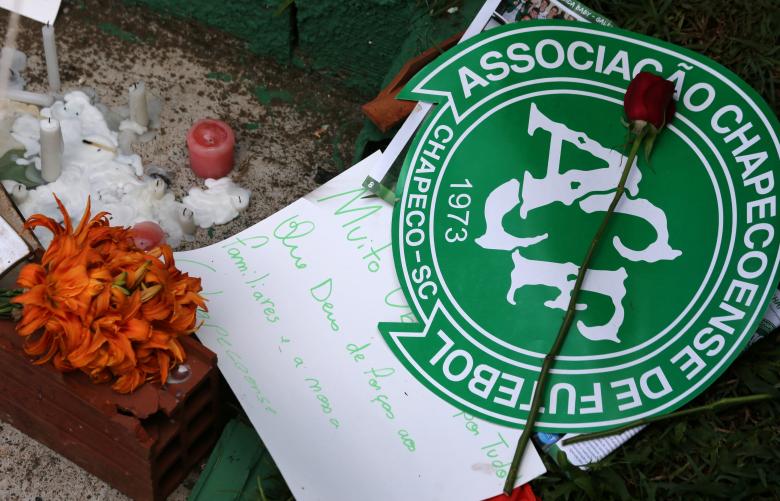 Flowers and messages are seen next to a Chapecoense soccer team flag in tribute to their players in front of the Arena Conda stadium in Chapeco Brazil