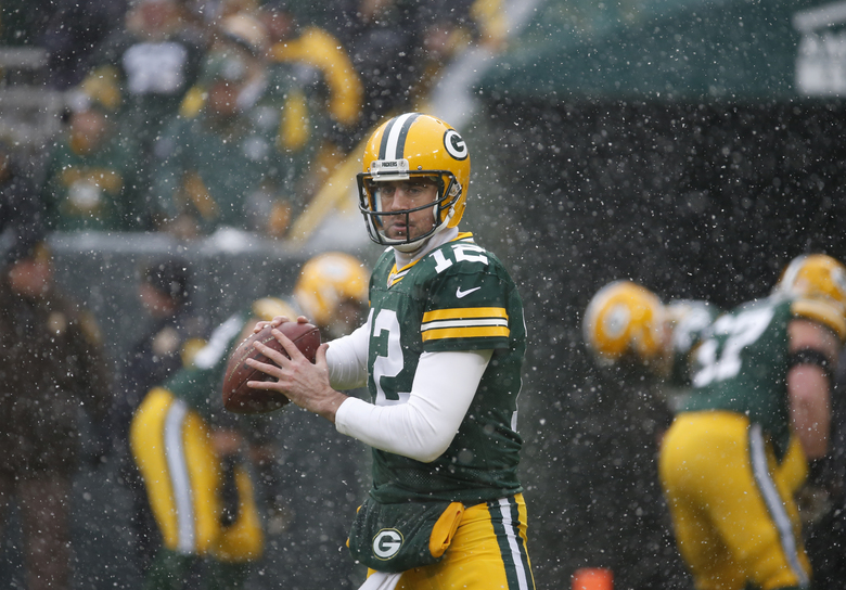 Green Bay Packers’ Aaron Rodgers warms up before an NFL football game against the Houston Texans