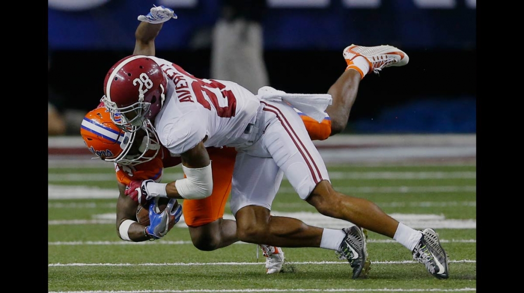 Florida wide receiver Antonio Callaway is tackled by Alabama defensive back Anthony Averett during the first half of the Southeastern Conference championship NCAA college football game Saturday Dec. 3 2016 in Atlanta