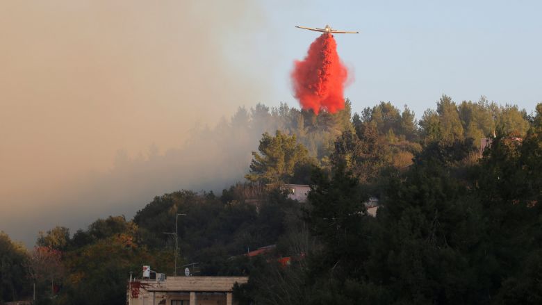 A firefighting plane drops fire retardant during a wildfire around the communal settlement of Nataf close to Jerusalem