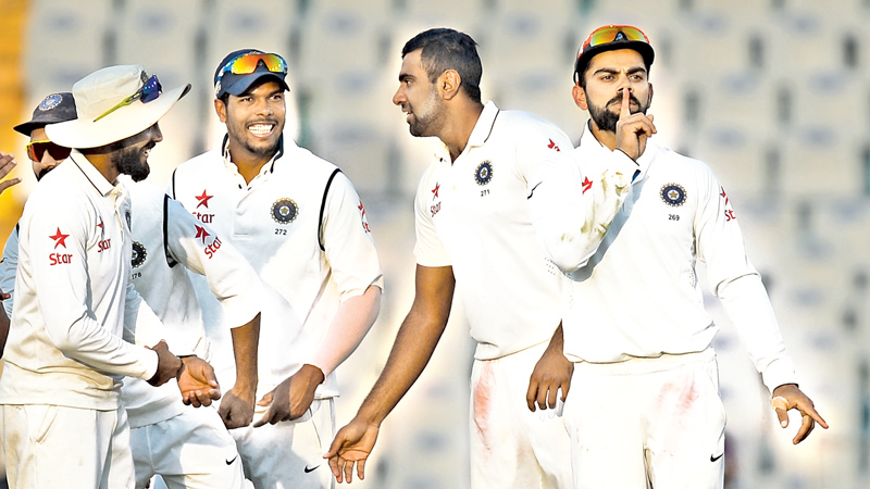 Indian captain Virat Kohli gestures towards supporters after R. Ashwin dismissed England batsman Ben Stocks on the third day of the third Test cricket match between India and England at The Punjab Cricket Association Stadium in Mohali on November