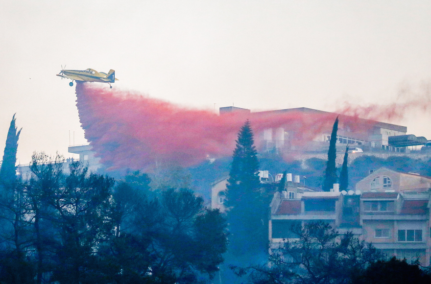 An Israeli firefighting airplane trying to extinguish a fire raging in Haifa Nov. 24 2016