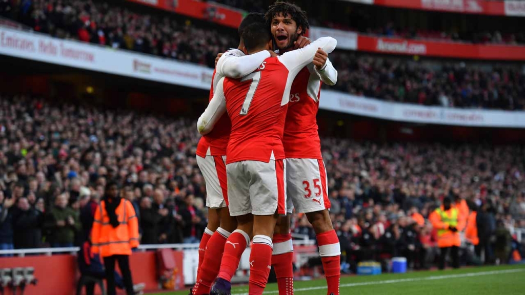 Arsenal's Chilean striker Alexis Sanchez celebrates with teammates after scoring the opening goal of the English Premier League football match between Arsenal and Bournemouth at the Emirates Stadium in London