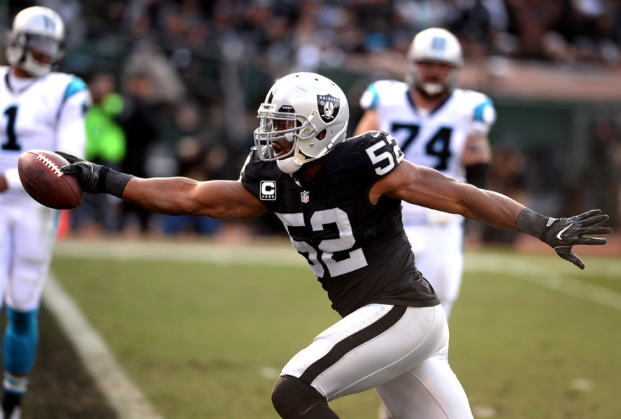 OAKLAND CA- NOVEMBER 27 Oakland Raiders defensive end Khalil Mack crosses the goal line for a touchdown after intercepting a pass by Carolina Panthers quarterback Cam Newton during second quarter action on Sunday Nov. 27 2016 at the Oakland Alameda C