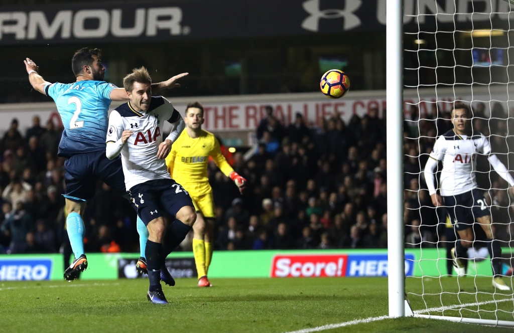 LONDON ENGLAND- DECEMBER 03 Christian Eriksen of Tottenham Hotspur scores his team's fourth goal during the Premier League match between Tottenham Hotspur and Swansea City at White Hart Lane