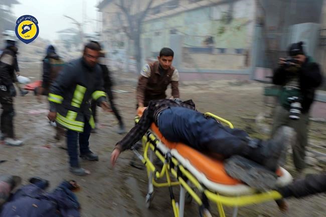 Syrian Civil Defense White Helmets which has been authenticated based on its contents and other AP reporting shows Civil Defense workers carrying a victim on a stretcher after artillery fire struck the Jub al Quba district