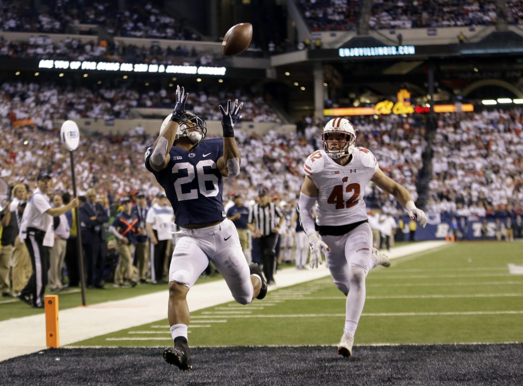 Penn State’s Saquon Barkley makes an 18-yard touchdown catch against Wisconsin's T.J. Watt during the second half of the Big Ten championship NCAA college football game Saturday Dec. 3 2016 in Indianapolis