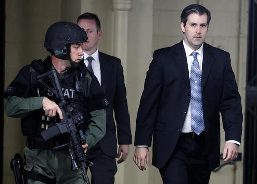 Michael Slager at right walks from the Charleston County Courthouse under the protection from the Charleston County Sheriff's Department after a mistrial was declared for his