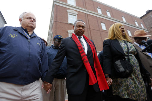 Rob Dewey left with the Coastal Crisis Chaplaincy and pastor Thomas Dixon second from left participate in a prayer vigil in front of the Charleston County Courthouse as the jury deliberates in the Michael Slager trial Monday Dec. 5 2016 in Charlest