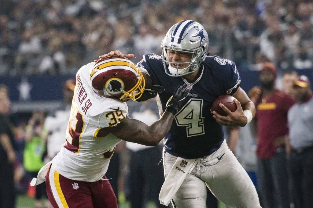 Nov 24 2016 Arlington TX USA Dallas Cowboys quarterback Dak Prescott stiff arms Washington Redskins strong safety Donte Whitner Sr during the second quarter at AT&T Stadium. Mandatory Credit Jerome Miron-USA TODAY Sports