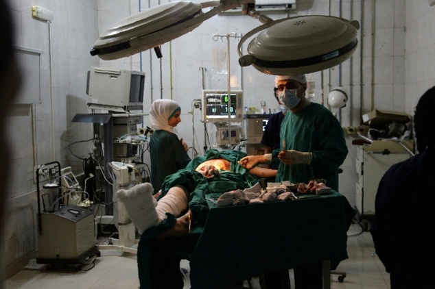 Medical staff work in an operating room at al Razi hospital in Aleppo