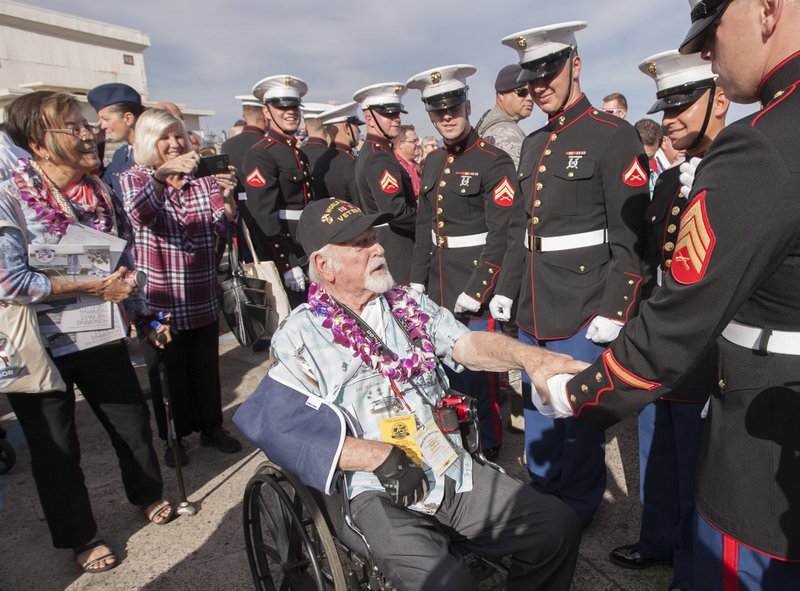 Pearl Harbor survivor Donald Barnhart center shakes the hand of a United States Marine while leaving the 75th Anniversary National Pearl Harbor Remembrance Day Commemoration on Kilo Pier at Joint Base Pearl Harbor-Hickam Wednesday Dec. 7 2016 in Hon