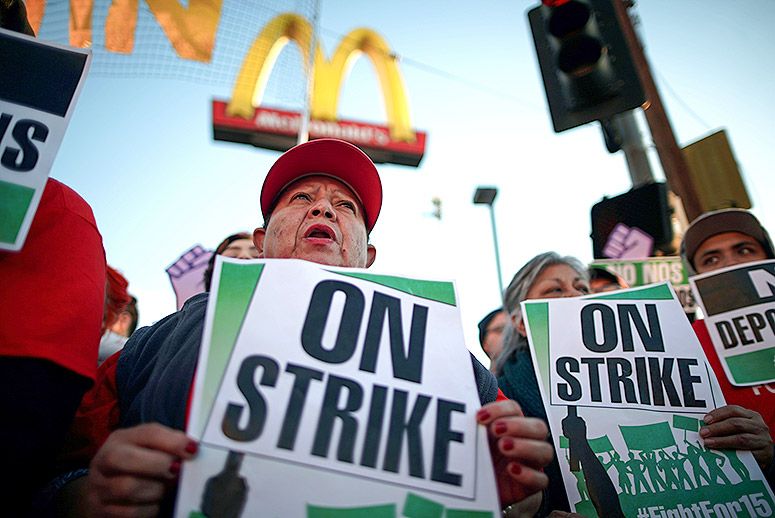 People participate in a'Fight for $15 wage protest in Los Angeles California