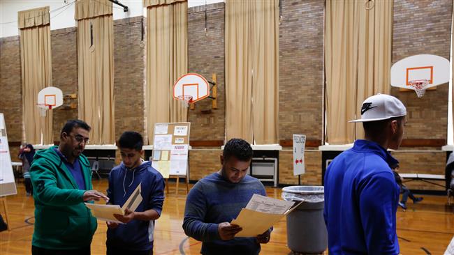 People wait to cast their ballots at Oakman Elementary School in the US presidential election